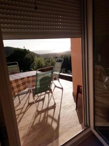 two chairs and a table on a balcony at Adriatic Sunset House in Petrovac na Moru