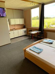 a room with a bed and a table and a kitchen at Zimmervermietung Deichmann in Landscheide