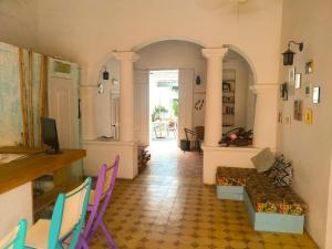 a living room with colorful chairs and a couch at Hostal Españolete in Santa Marta