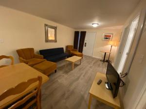 a living room with a couch and a table at Oceanfront Twilight Surf Hotel in Myrtle Beach