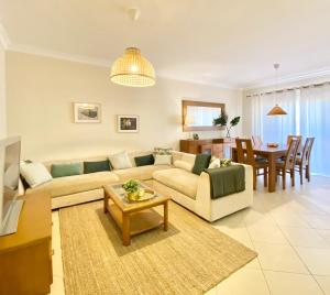 un soggiorno con divano e tavolo di Amazing 2Bedroom apartment in Victoria Boulevard a Vilamoura