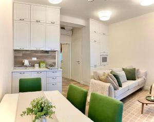 a living room with a couch and a table and chairs at Apartment Pupa in Brela