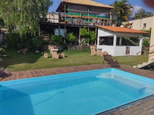 a swimming pool in the backyard of a house at Pousada Só Alegria in Mario Campos