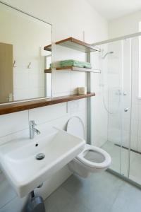a bathroom with a toilet and a sink and a shower at Apartmány Pokoj Zvolen in Zvolen