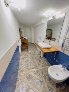 a bathroom with two sinks and a mirror at Coco's Apartment in Meta