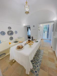 a white table with plates of food on it at Coco's Apartment in Meta