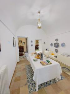 a white room with a table and plates on the wall at Coco's Apartment in Meta