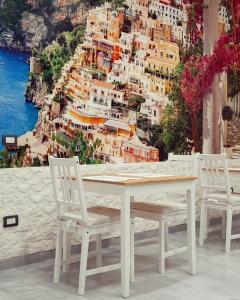 a table and chairs with a view of positano at Brighter's Room in Naples