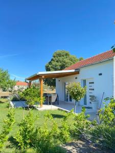 a view of a house with a pergola at Holiday House Lucia in Sukošan