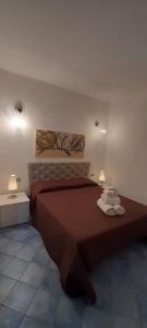 a bedroom with a large bed with two lamps at Villa Lucia in Lampedusa