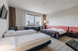 Postel nebo postele na pokoji v ubytování Hotel Continental