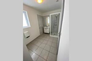 a bathroom with a shower stall and a toilet at Gîte du Clos Basté in Moncaup