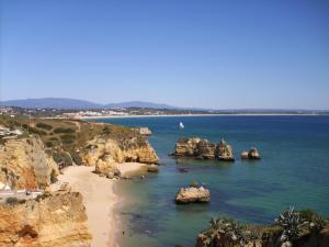 a view of a beach with rocks in the water at Vilamar in Luz
