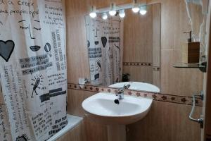 a bathroom with a sink and a mirror at Casa Gisbert Centro histórico Parking Free in Cartagena +18 photos