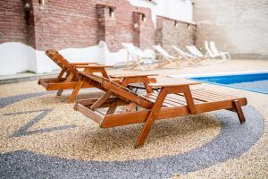 a group of lounge chairs and a pool at JEZ&SPI Plánice in Plánice