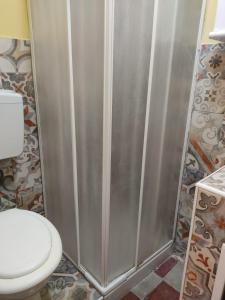 a bathroom with a toilet and a shower at Il Vano della Scimmia Aeroporto Catania in Catania