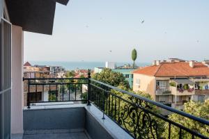 a balcony with a view of a city at Bogdanovi Guest House in Chernomorets +45 photos