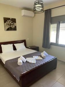 a bedroom with a bed with towels on it at Villa Soula in Paralía Avdhíron