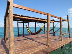 a wooden dock with a wooden board on top of it at Casa Lamat in Bacalar