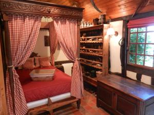 a bedroom with a canopy bed in a room with a window at Le gîte des Trois Vaches in Brionne