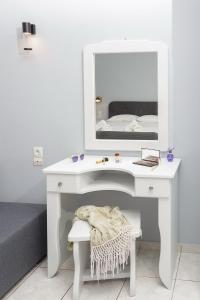 a white desk with a mirror and a bed at Sole Mare Seaside Apartments in Gouves