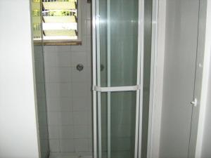 y baño con ducha y puerta de cristal. en Kookaburra Inn, en Brisbane