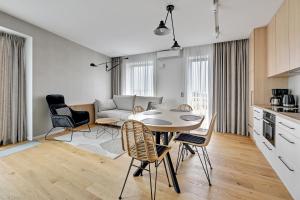 a kitchen and living room with a table and chairs at Marina View - Yacht Park Premiere in Gdynia
