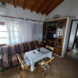 a living room with a table and a couch at Villa Amfithea in Skiathos