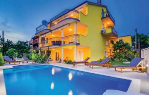 a house with a swimming pool in front of a house at Apartman 2 in Senj