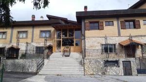 a house with stairs leading up to the front door at Residence Fonte Eremita in Roccaraso