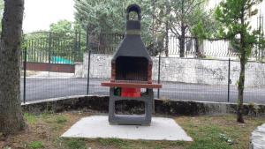 a bench sitting in a park next to a tree at Residence Fonte Eremita in Roccaraso +12 photos
