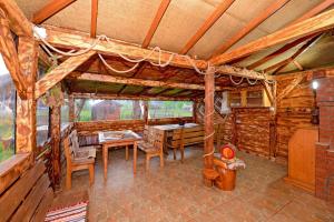a dining room with a table and chairs in a cabin at Casa Teo&Andreea in Vatra Dornei