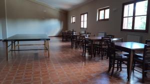 a dining room with tables and chairs and windows at Residence Fonte Eremita in Roccaraso
