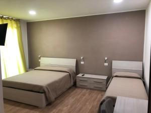a small bedroom with two beds and a window at West Ponente in Francavilla al Mare