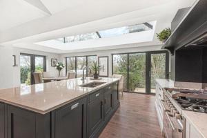 a large kitchen with a large island in the middle at Harrogate boutique lodge with heated pool and hot tub in Staveley