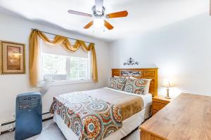 a bedroom with a bed and a ceiling fan at Aspen Cottage in Bar Harbor