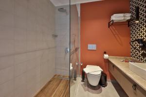 a bathroom with a shower and a toilet and a sink at Neva Kaş in Kaş