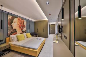 a bedroom with a bed with a painting of a woman at Neva Kaş in Kaş