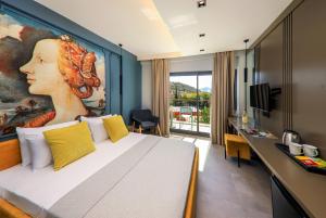 a hotel room with a large painting of a woman at Neva Kaş in Kaş