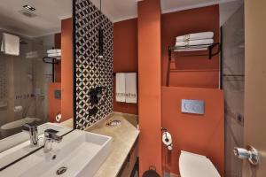 a bathroom with a sink and a mirror at Neva Kaş in Kaş