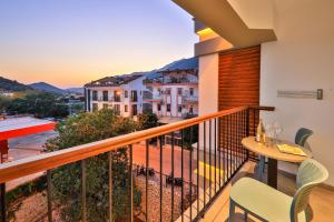 a balcony with a table and chairs and a view at Neva Kaş in Kaş