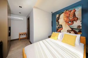 a bedroom with a large painting of a woman at Neva Kaş in Kaş