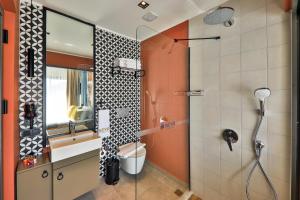 a bathroom with a shower with a toilet and a sink at Neva Kaş in Kaş