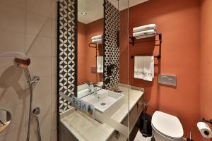 a bathroom with a sink and a toilet at Neva Kaş in Kaş