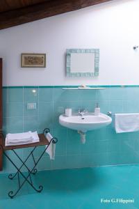 a bathroom with a sink and blue tiles at Casa Visnenza Bed & Breakfast in Capo di Ponte +22 photos