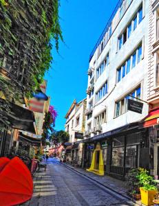 a city street with buildings and a red umbrella at Preferred Hotel Old City in Istanbul