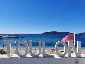 a sign on a beach with the word taxi at Studio avec vue in Toulon