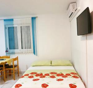 a bedroom with a bed with red roses on it at Guesthouse Pejo in Poreč