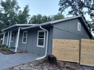 a house with a fence and a garage at Nice house between two beaches. in Gulf Breeze