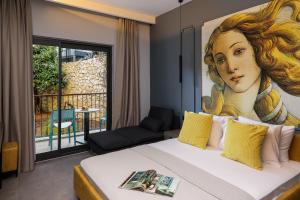a bedroom with a bed with a painting of a woman at Neva Kaş in Kaş